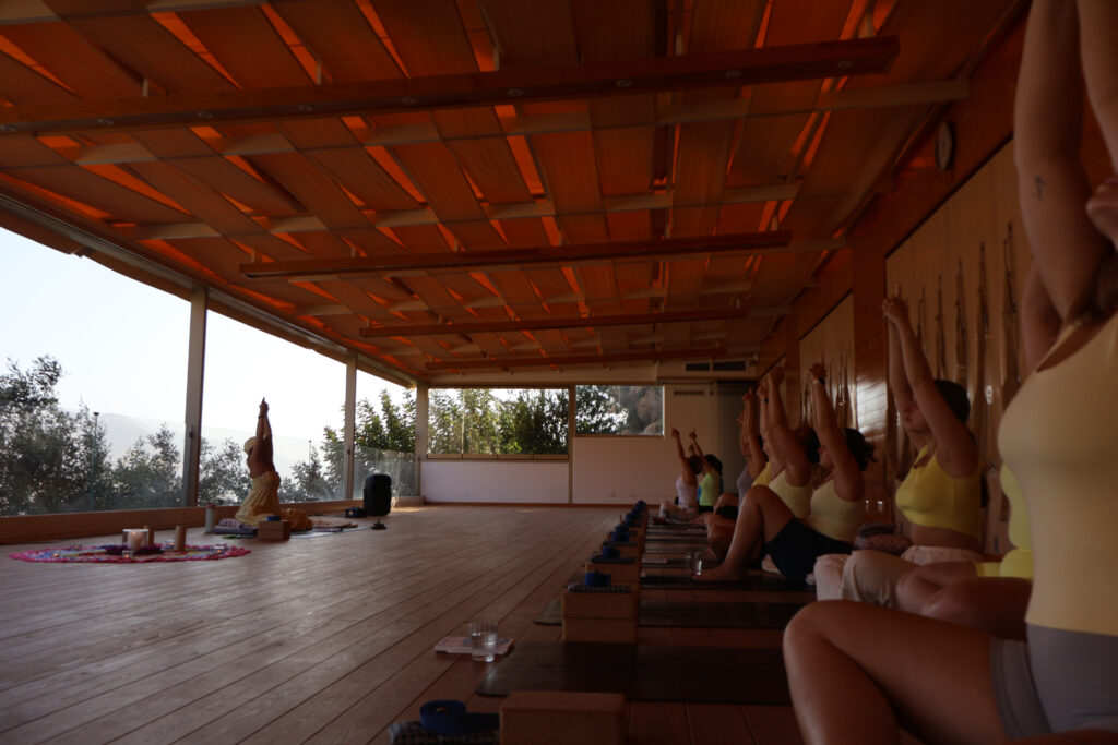 Restorative yoga class with mountain views during Cece Yoga Greece 2025 women’s retreat.