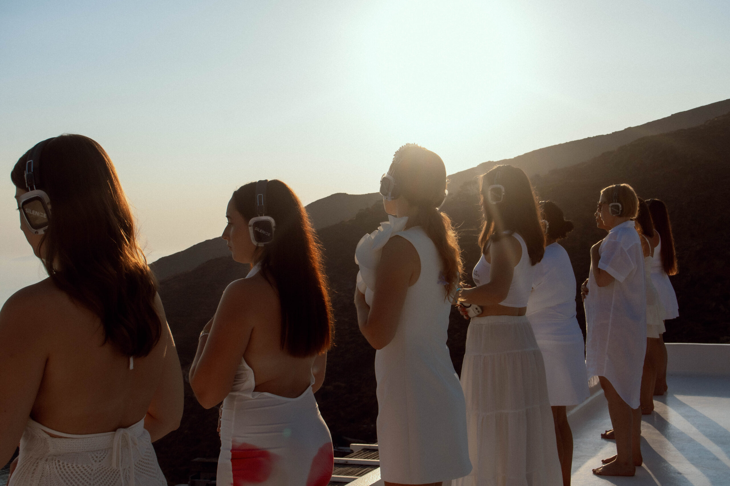 Women experiencing a peaceful sound meditation overlooking the mountains in Greece